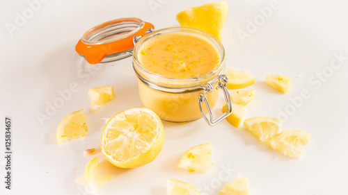 Lemon curd in mason jar with sliced lemon garnish photo