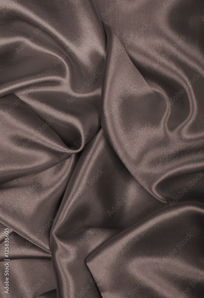 Smooth elegant golden silk or satin as background. In Sepia tone