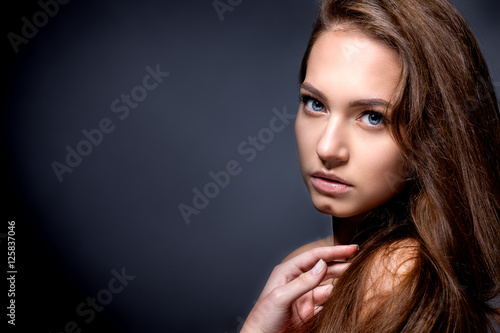 Portrait of a beautiful girl on a gray background