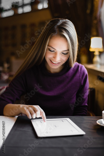 Young woman searching for information in tablet