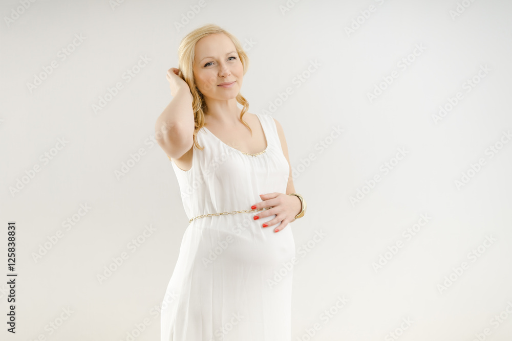 beautiful pregnant woman in a white dress on a white background beautiful pregnant woman in a white dress on a white background
