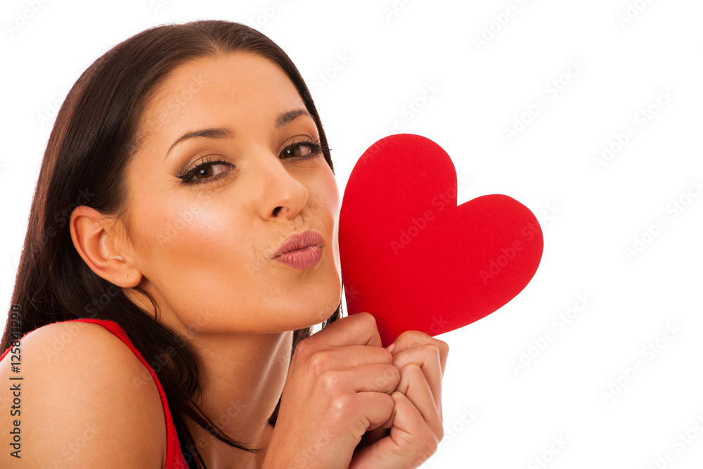 Woman in love wearing red dress holding red heart sending messag Woman in love wearing red dress holding red heart sending messag