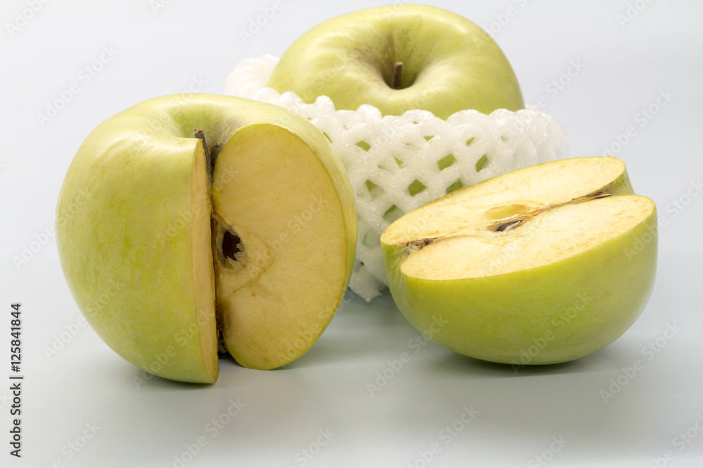 Sliced green apples on a white table. Sliced green apples on a white table.