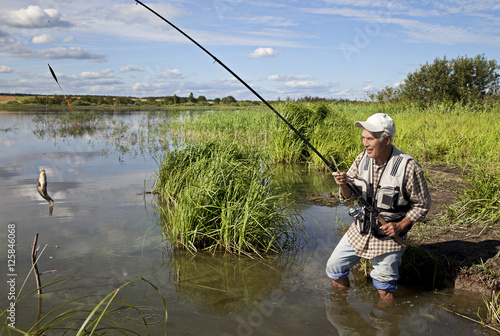 fisherman fishing on a river bank