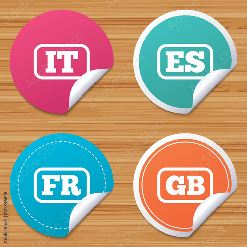Round stickers or website banners. Language icons. IT, ES, FR and GB translation symbols. Italy, Spain, France and England languages. Circle badges with bended corner. Vector