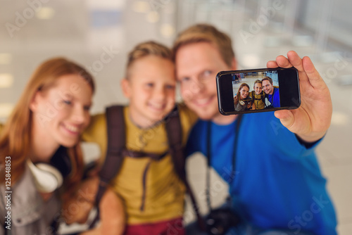 Happy family making photo in airport