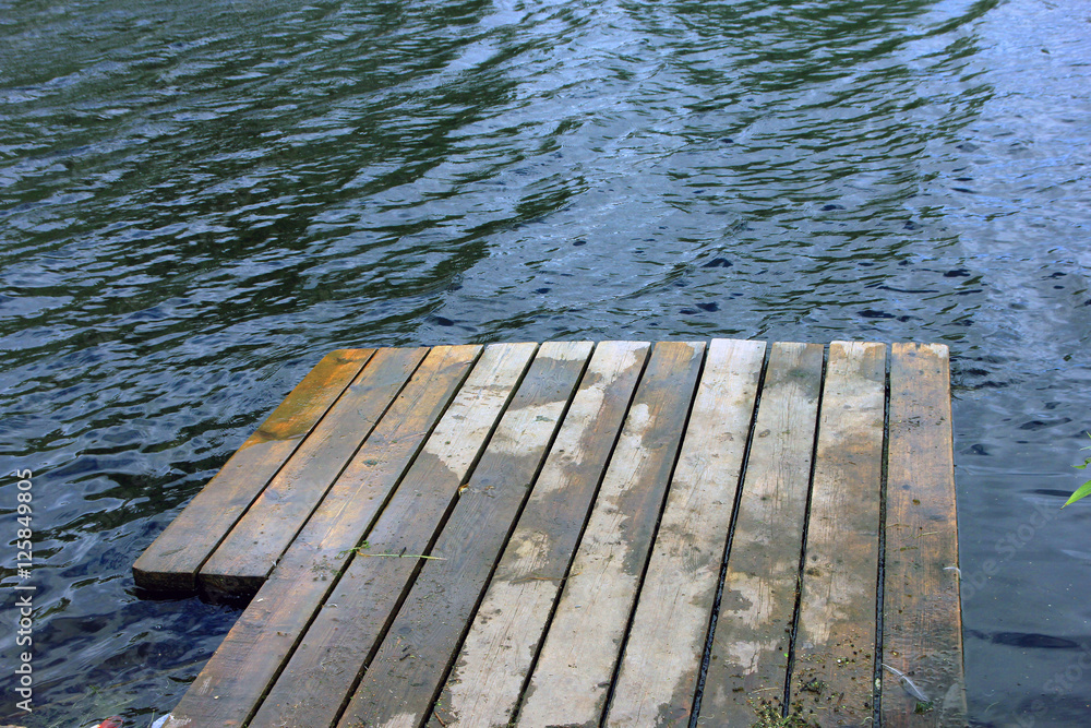Fototapeta premium wooden jetty at a small village the river in Russia in summer