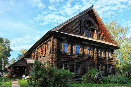 beautiful vintage traditional Russian log house with wooden wind