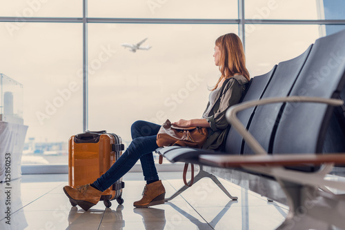 Smiling girl waiting for boarding