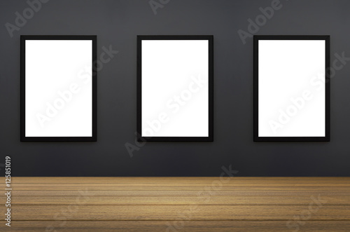 three Black frame hanging on a grey wall.white isolate.perspective wooden floor.for advertiser.graphic design
