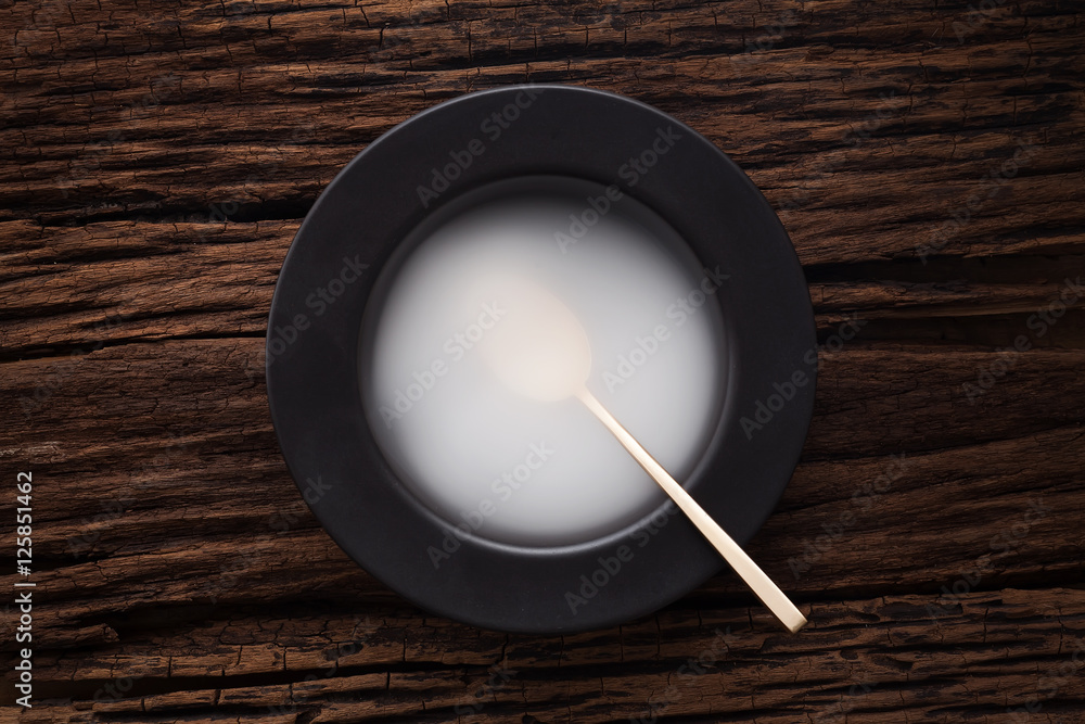black empty bowl spoon on wooden table background black empty bowl spoon on wooden table background