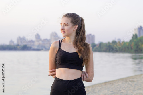 Young woman rests during fitness training exercises outdoor in m