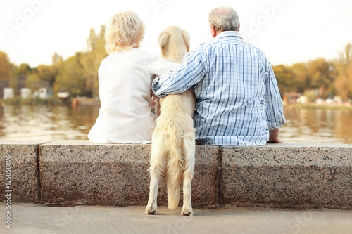 Senior couple sitting back on bund photo