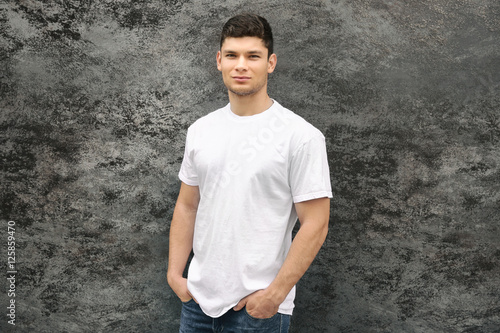 Handsome man on wall backgr...