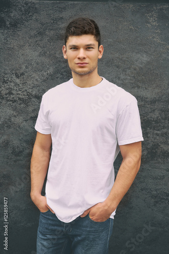 Handsome man on wall backgr...