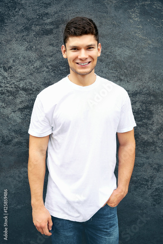 Handsome man on wall backgr...
