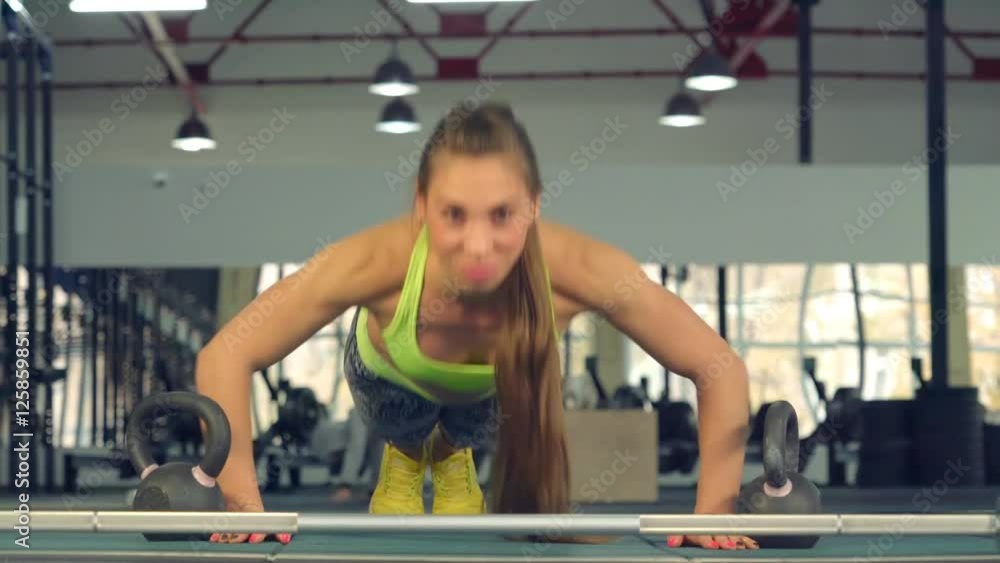 She Pushed Off the Floor Looking Straight Into the Camera. in the Foreground of the Neck From the Rod and Metal Weights She Pushed Off the Floor Looking Straight Into the Camera. in the Foreground of the Neck From the Rod and Metal Weights