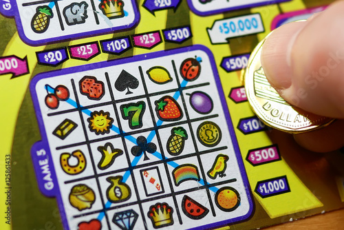 Close up man scratching lottery ticket.