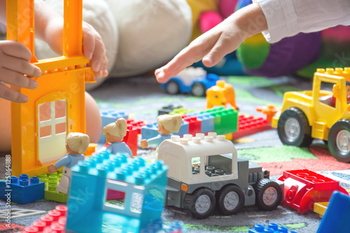 small children playing in kindergarten with colorful toys and Le