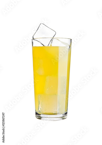 Glass of orange soda drink cold with ice cubes