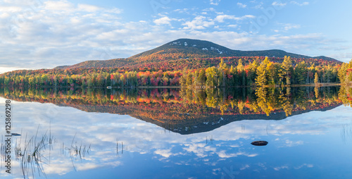 Blue Mountain in brilliant autumn colors reflecting in Lake Durant at sunset