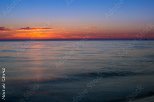 Sunrise at sea shore. Colorful sky.