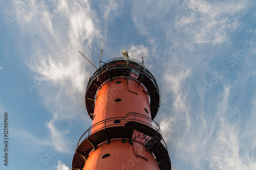 Lighthouse with sky and clouds background, located in Jastrzebia Gora at the Baltic Sea coast Poland. photo