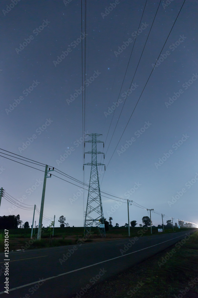 High voltage pole in night time with star on sky background