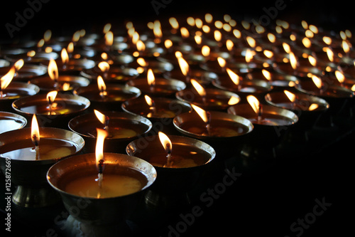  Charity. Praying candles in a temple.