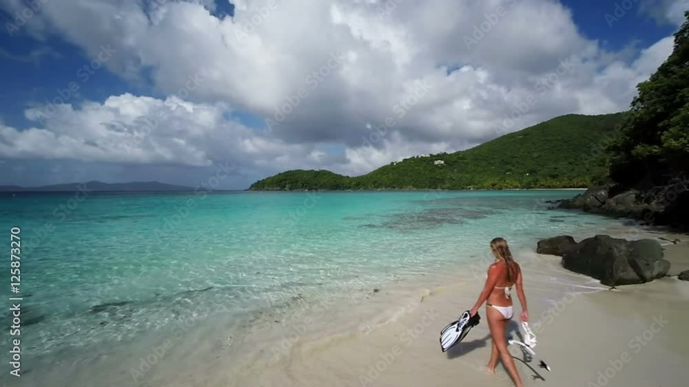 Aerial view of a bikini woman walking out to snorkel, st john, United States Virgin Islands Aerial view of a bikini woman walking out to snorkel, st john, United States Virgin Islands