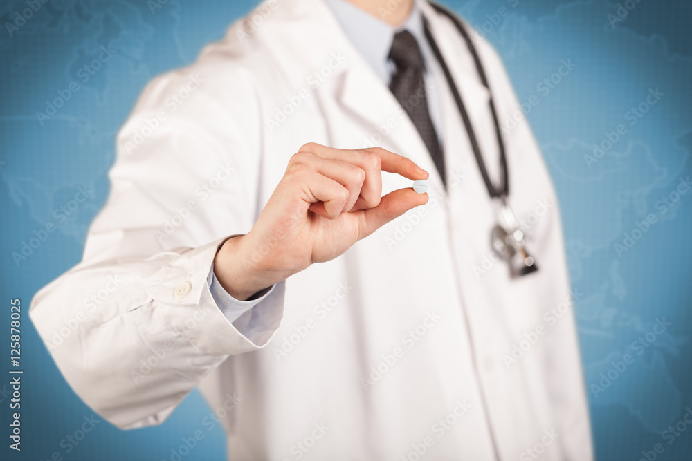 Doctor in white holding a pill Doctor in white holding a pill