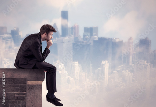 Sales person sitting on top of a tall building