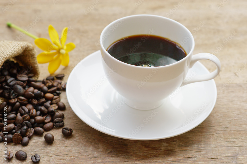 Coffee cup and coffee beans on table Coffee cup and coffee beans on table