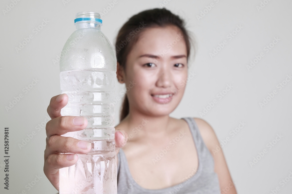 Young woman drinking water on white background. Young woman drinking water on white background.