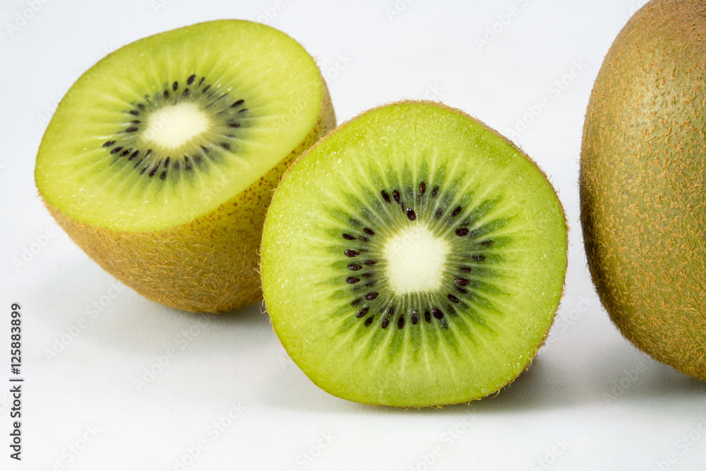 Whole kiwi fruit and his sliced segments isolated on white backg Whole kiwi fruit and his sliced segments isolated on white backg
