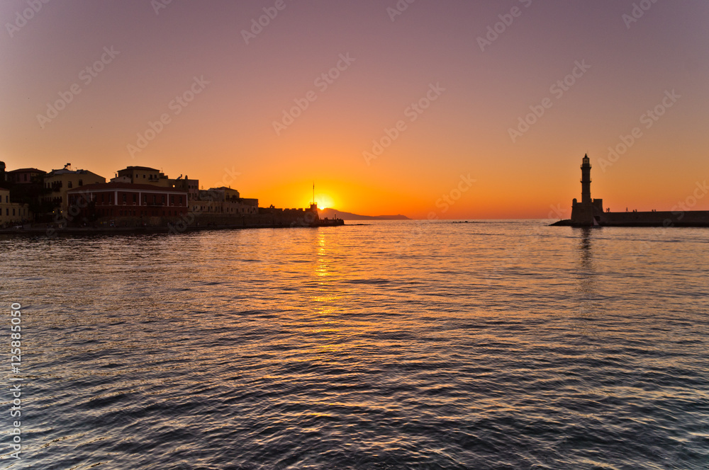 Sunset at the entrance of old harbor of Hania, island of Crete, Greece Sunset at the entrance of old harbor of Hania, island of Crete, Greece