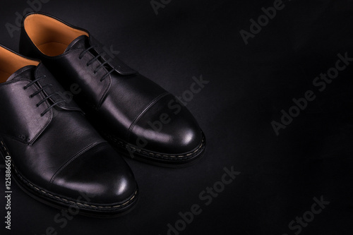 Black oxford shoes on background. Back view. Copy space.