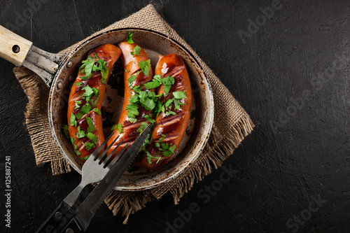 Quadro em tela Fried sausage on an old pan