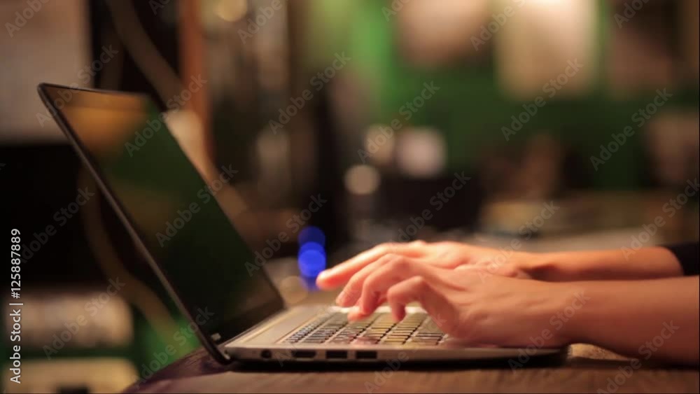 Still shot of a woman's hands working on a laptop. Still shot of a woman's hands working on a laptop.