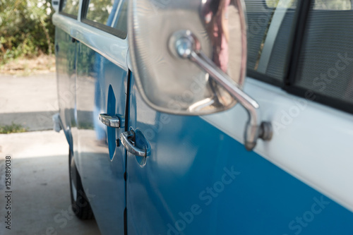 Close up of a vintage blue car and rear view mirror