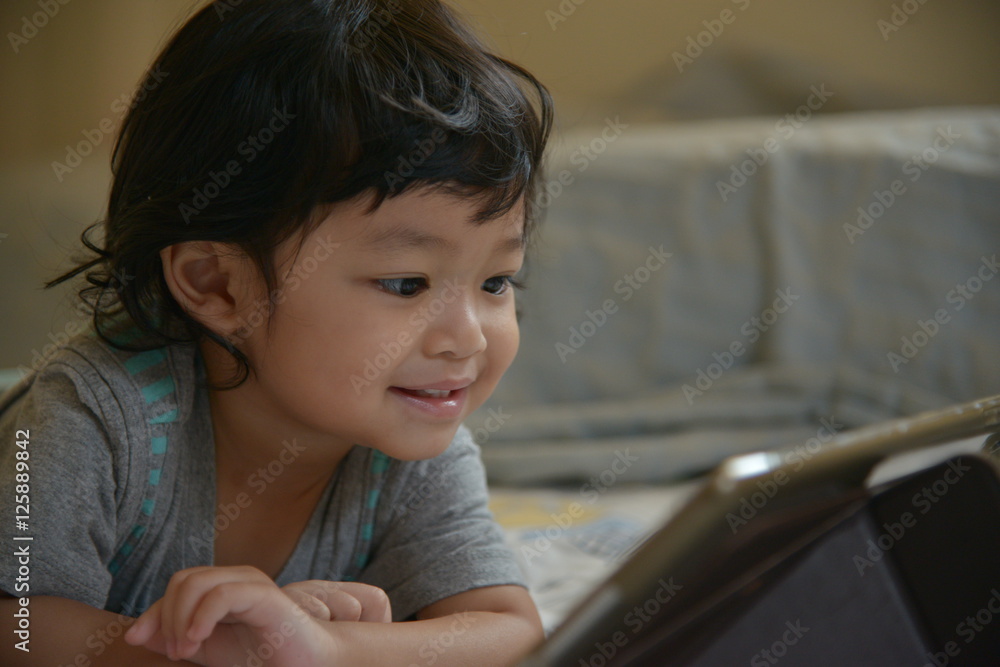 little kid looking tablet and smile little kid looking tablet and smile