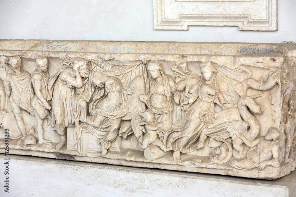 Bas-relief on the ancient sarcophagus in the baths of Diocletian in Rome. Italy