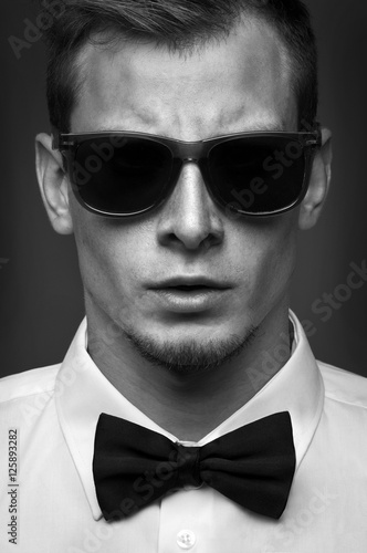 Portrait of men with sunglasses in white tuxedo