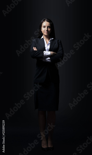 Successful businesswoman isolated on black