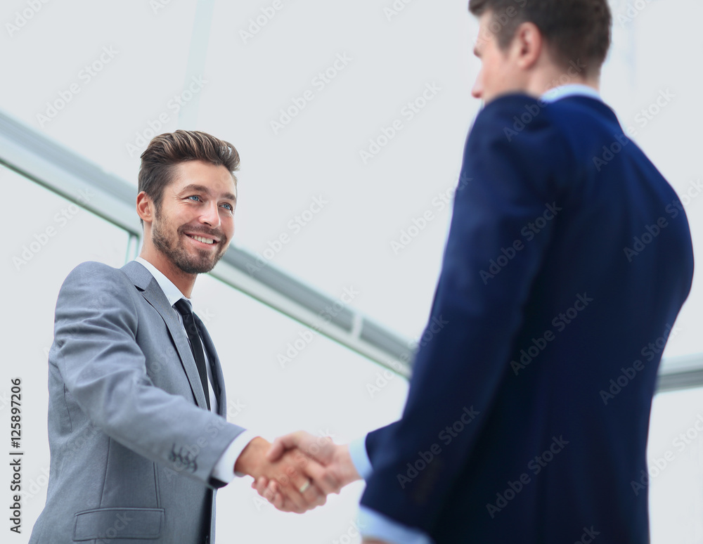 Business colleagues sitting at a table during a meeting with two Business colleagues sitting at a table during a meeting with two