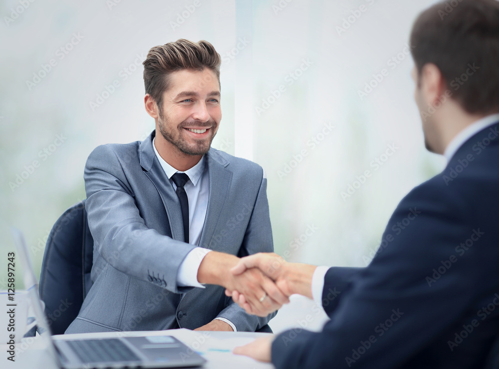 Two business colleagues shaking hands during meeting Two business colleagues shaking hands during meeting