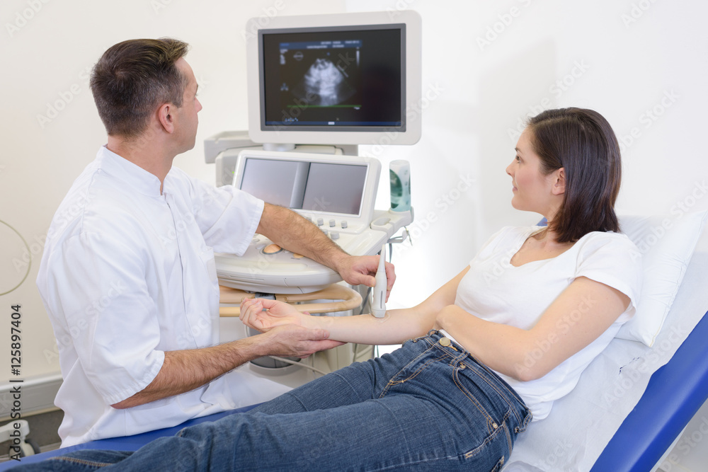doing an ultrasound on the arm doing an ultrasound on the arm