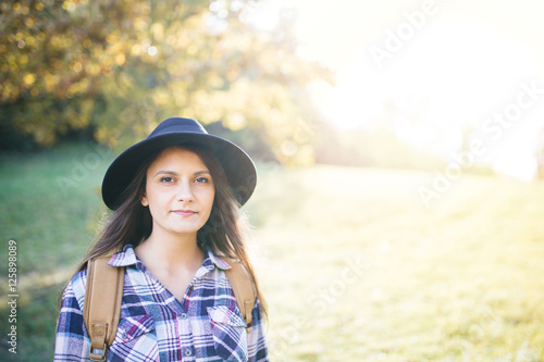 Hipster girl with hat posing outdoor