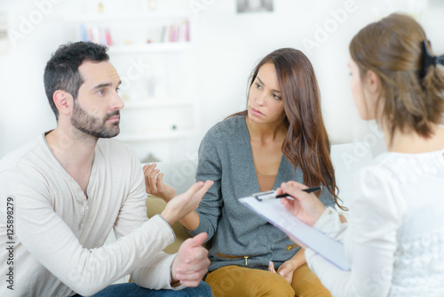 stressed young couple quarrel at the psychologist photo