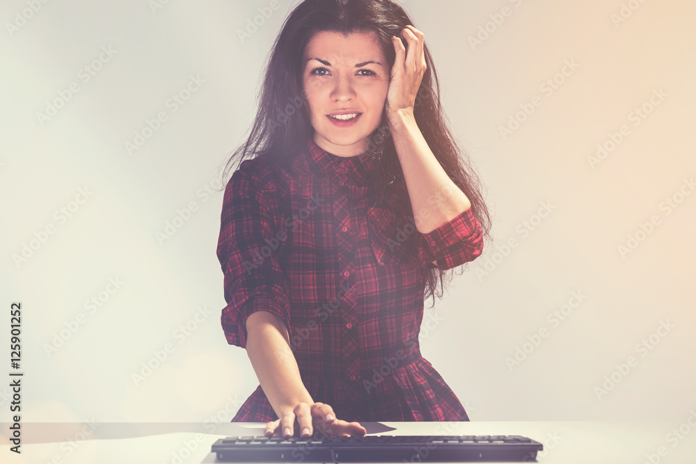 Confused young woman and a keyboard